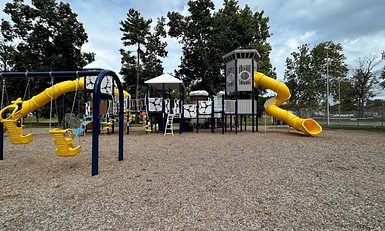 A playground with a yellow slide and yellow swings.  Hoffer Park, Middletown PA